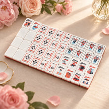 White blank tiles beside red-outlined North and South wind tiles, floral tiles and patriotic Joker designs.